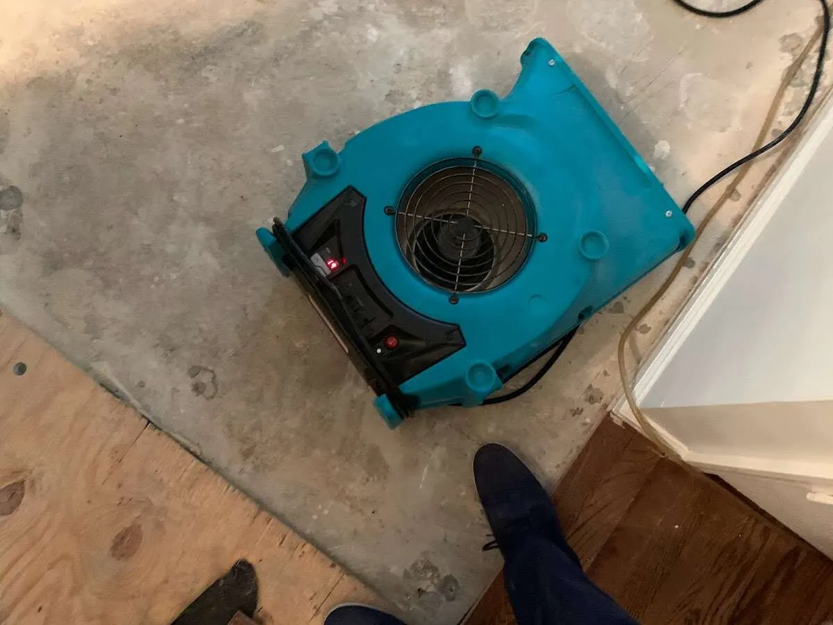 Air mover drying subfloor during Commercial Water Damage Restoration in Tinton Falls